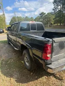 Black Chevrolet Silverado pickup with a repaired and refinished rear bed side after collision repair in Cabot, Arkansas
